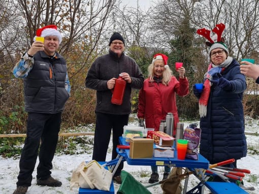 A group of volunteers enjoy Coffee and Mince Pies outsider at Hill Rise